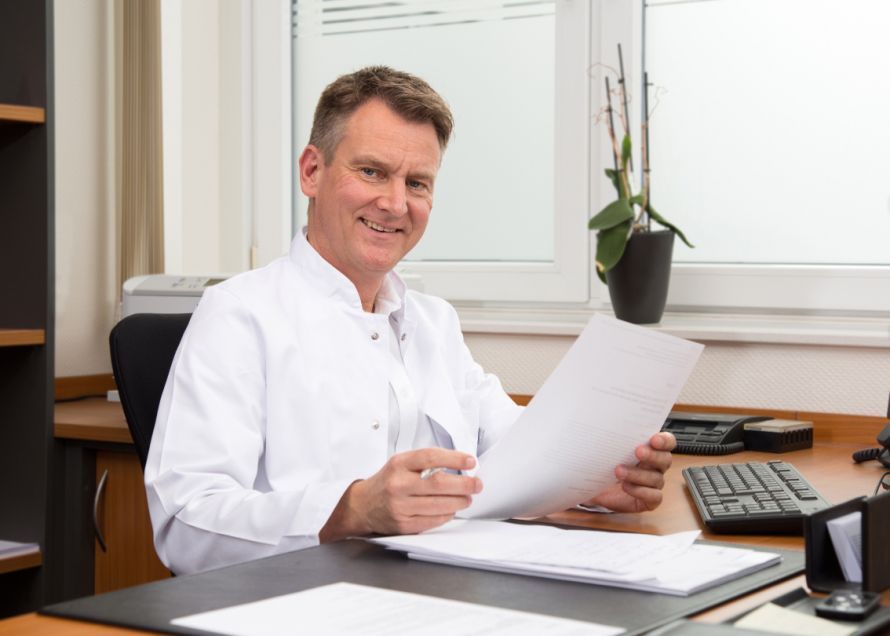 Prof. Langenbach with a sheet of paper
